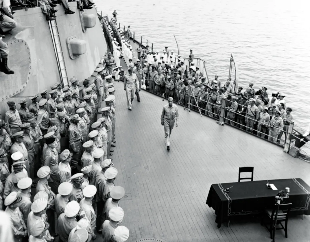 Allied leaders, including General Douglas MacArthur and Admiral William Halsey, walk past American naval and military officers gathered on board the Missouri ​​​​​​​for the September 2, 1945, surrender ceremony.