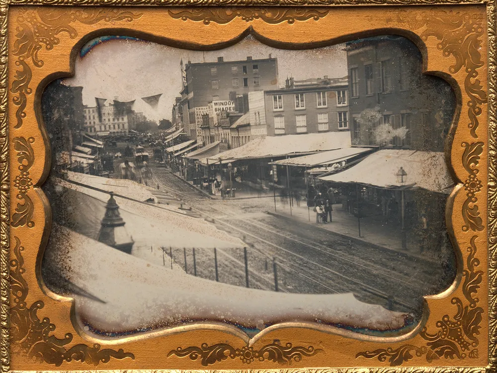 Awnings line a street in New York City in the 1850s.