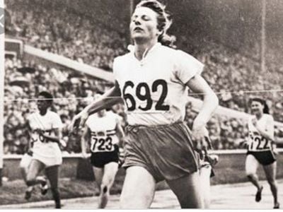 Fanny Blanker-Koen crosses the finish line to become the first triple champion of the 14th Olympic Games.