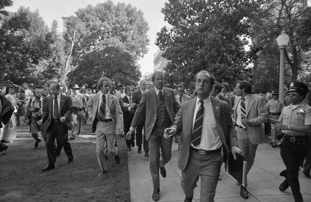 Secret Service agents rush Gerald Ford to safety following a September 5, 1975, assassination attempt in Sacramento.