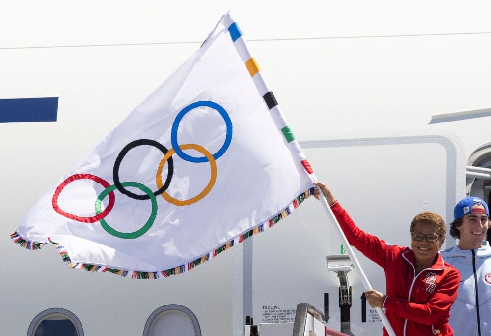 Los Angeles Mayor Karen Bass waves an Olympic flag