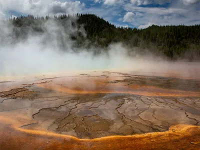 Minerals and algae form patterns in the scalding hot water at Grand Prismatic Spring in Yellowstone National Park&#39;s Midway Geyser Basin.&nbsp;Yellowstone National Park has more than 10,000 thermal features, making it the largest concentration of active geysers in the world.