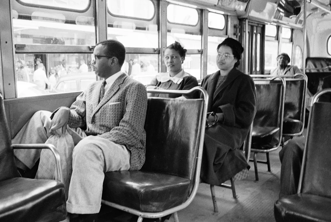 Rosa Parks (center, in dark coat and hat) rides a bus in Montgomery, Alabama, on December 26, 1956.