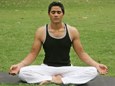 A yoga instructor practices a breathing exercise.