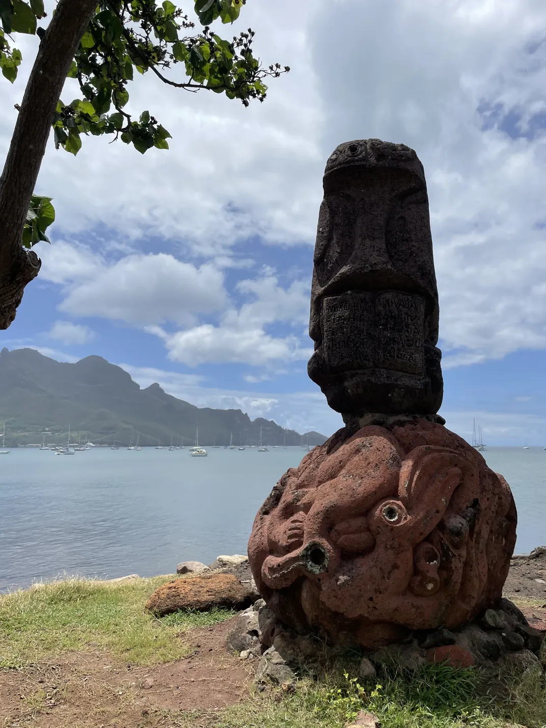 Stone statue with water in the background