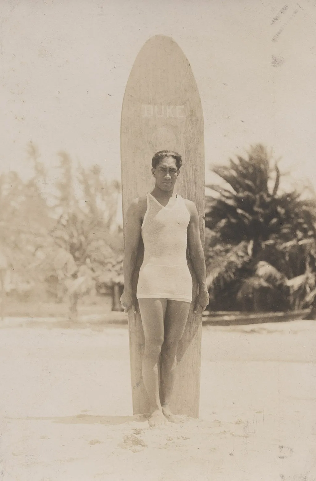 Kahanamoku with his surfboard